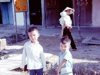 Two boys helping with the shopping - Phouc Vinh business district.